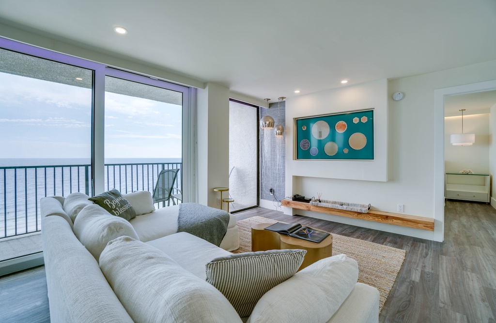 Unwind in your bright coastal living room, where floor-to-ceiling windows frame endless ocean views and plush seating invites you to relax in style.