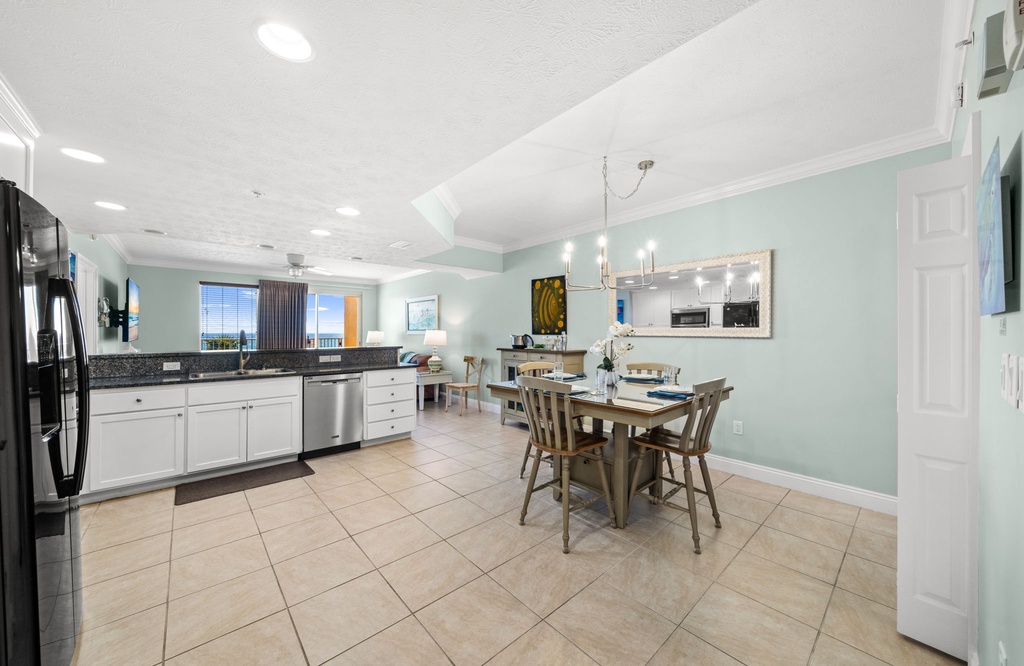 Open kitchen and dining area with modern appliances and coastal views.