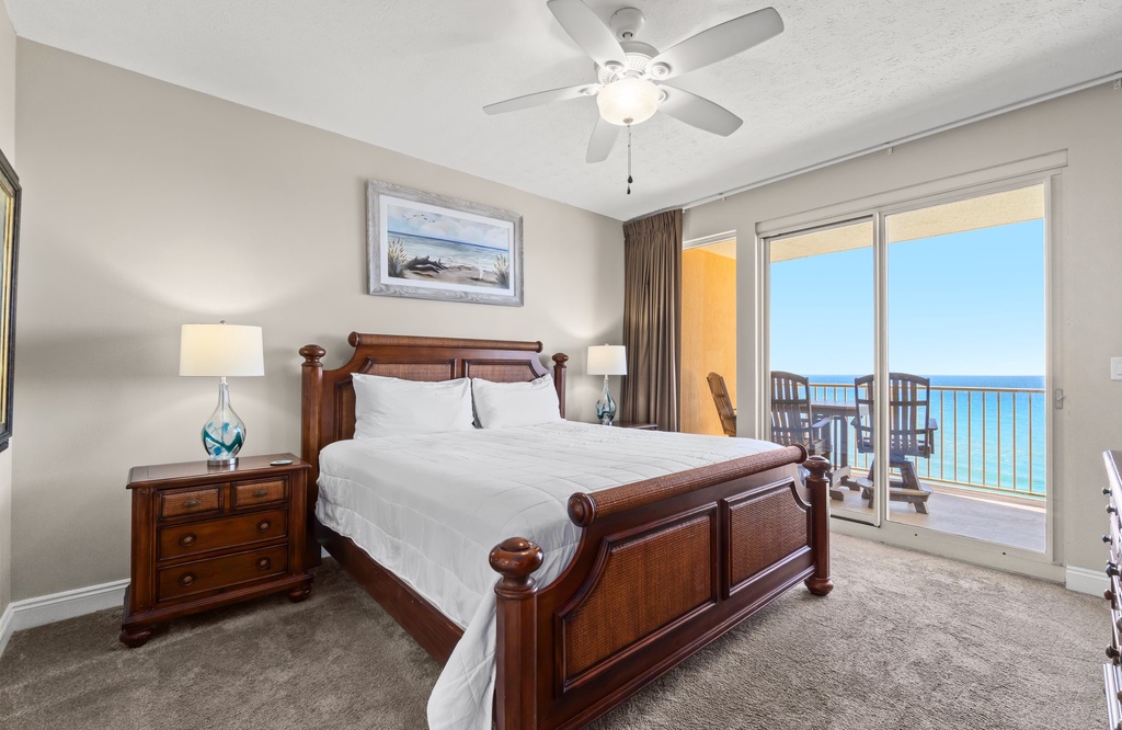 Relax in this bedroom with ocean views and access to a balcony.