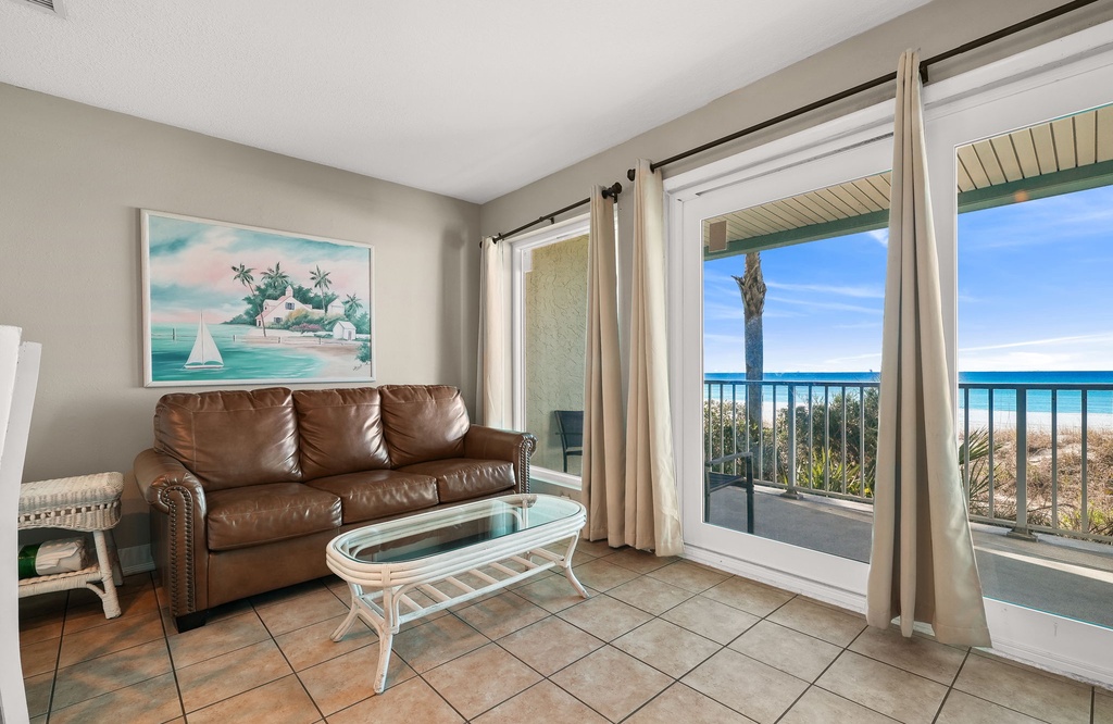 Relax in your comfortable living space with stunning ocean views right from your balcony doors.