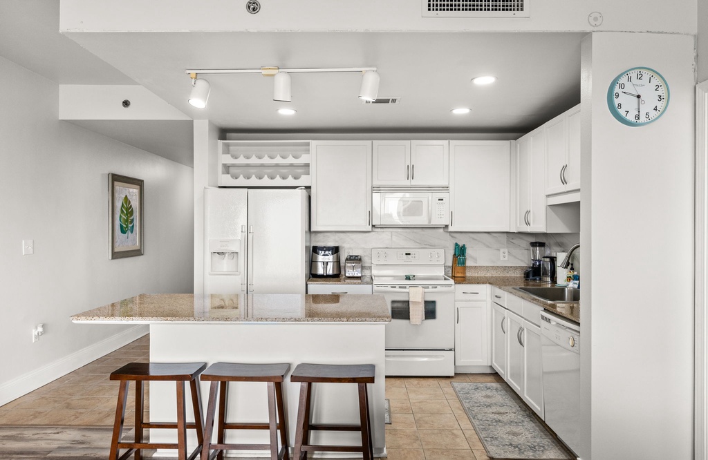 Your spacious kitchen is fully equipped with granite countertops, modern appliances, and plenty of storage. Whether you're making morning coffee or preparing a meal, you'll have everything you need in this bright, inviting space.