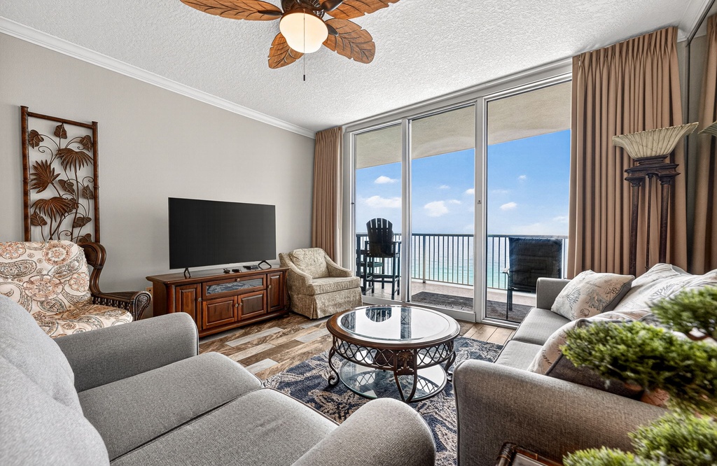Sink into plush seating as ocean breezes drift through your private balcony, where turquoise waters stretch endlessly before you.