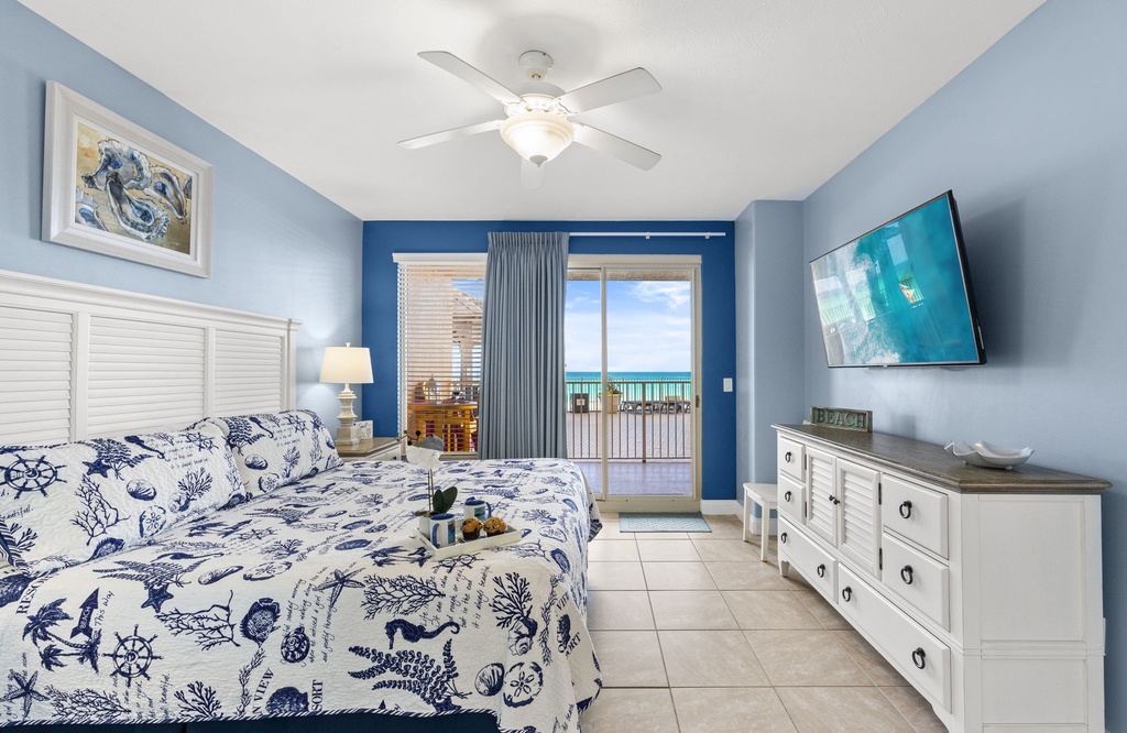 Relax in this coastal-themed bedroom with ocean views and direct balcony access.