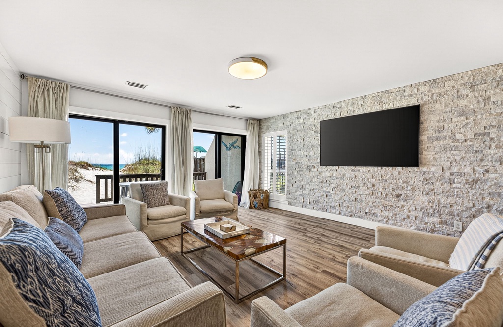 Unwind in your spacious living room with ocean views and coastal breezes just steps from the sand. The beach awaits through those windows.