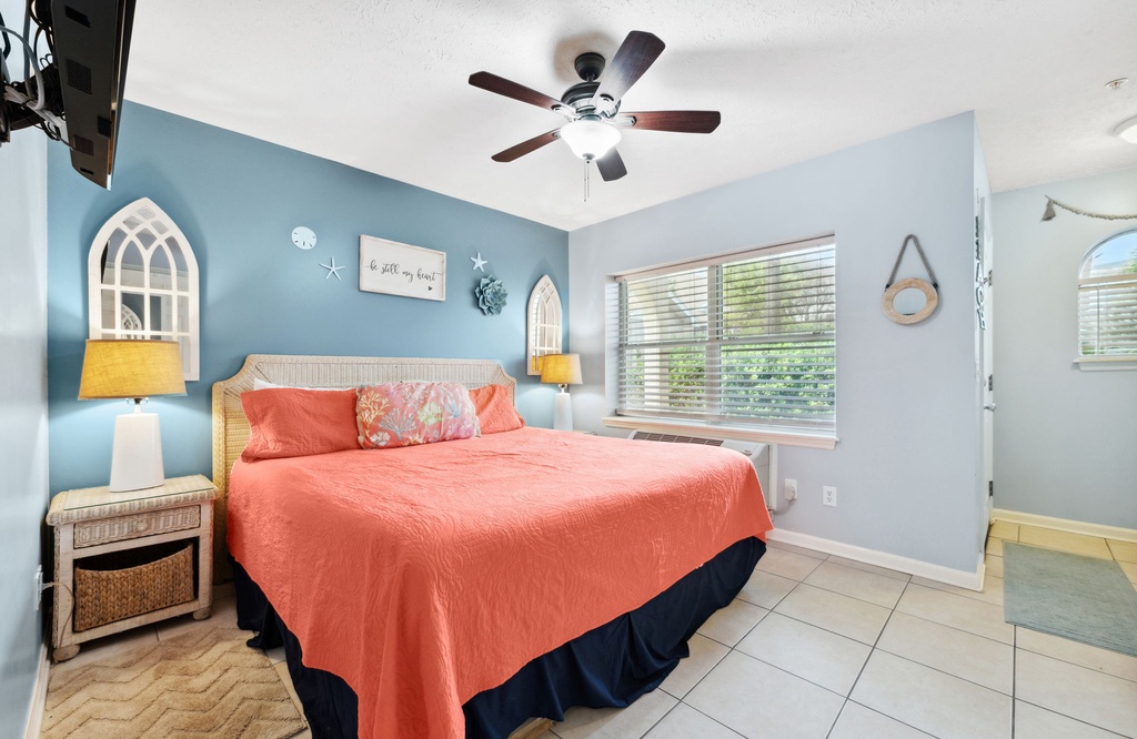 Cozy bedroom with a bed and calming blue accent wall.