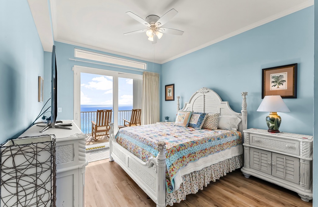 Cozy bedroom with ocean views and a balcony seating area