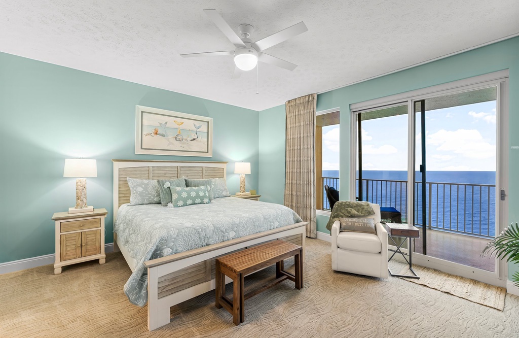Relax in this coastal bedroom with ocean views and calming blue walls.