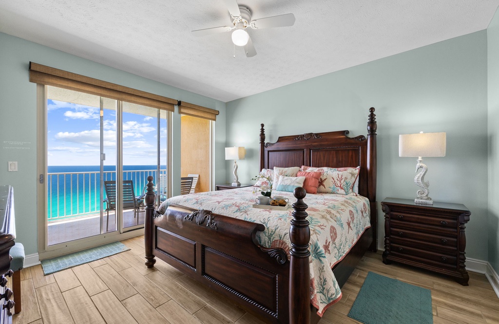 Relax in this coastal bedroom with ocean views and classic wooden furnishings.