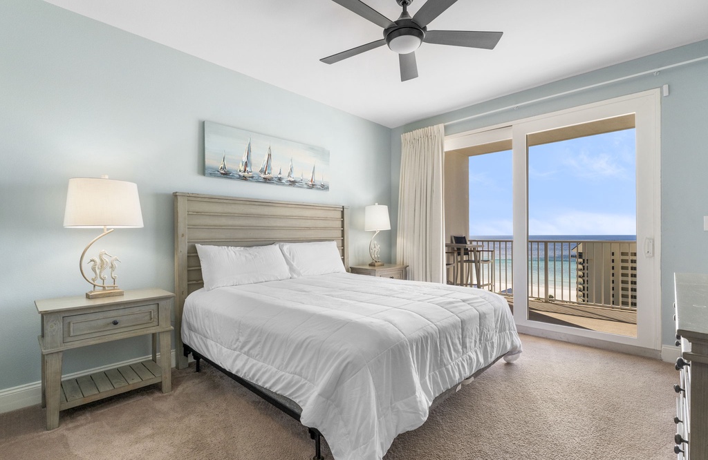 Relax in this modern bedroom with ocean views from the balcony.