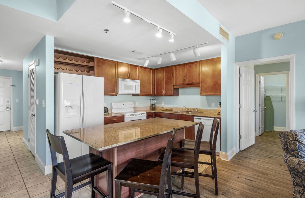 spacious kitchen with wooden cabinetry and a large island for dining