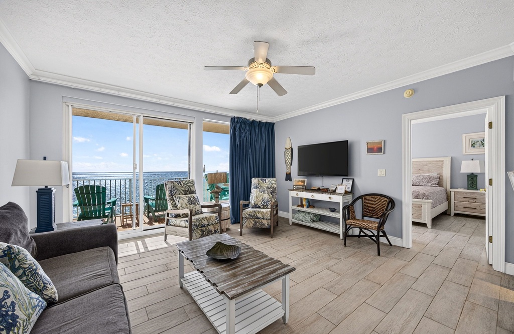 Step into your coastal retreat where the ocean stretches endlessly before you through expansive windows. Relax in the airy living room with comfortable seating and your private balcony just steps away—perfect for morning coffee with a view.