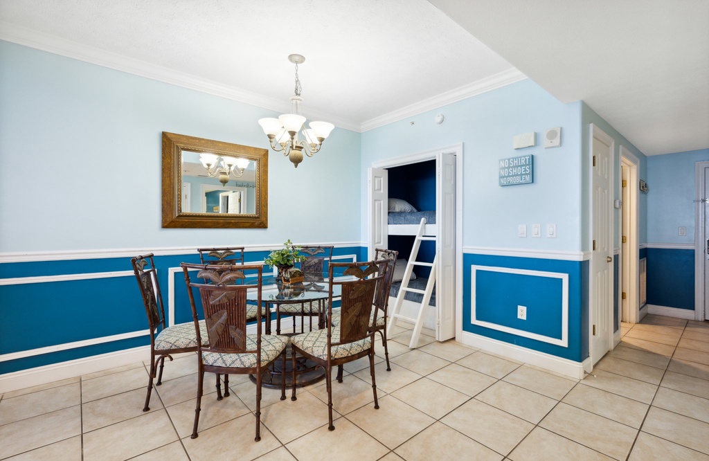 Dining area w/ seating for shared meals, framed by cheerful blue accents & natural light