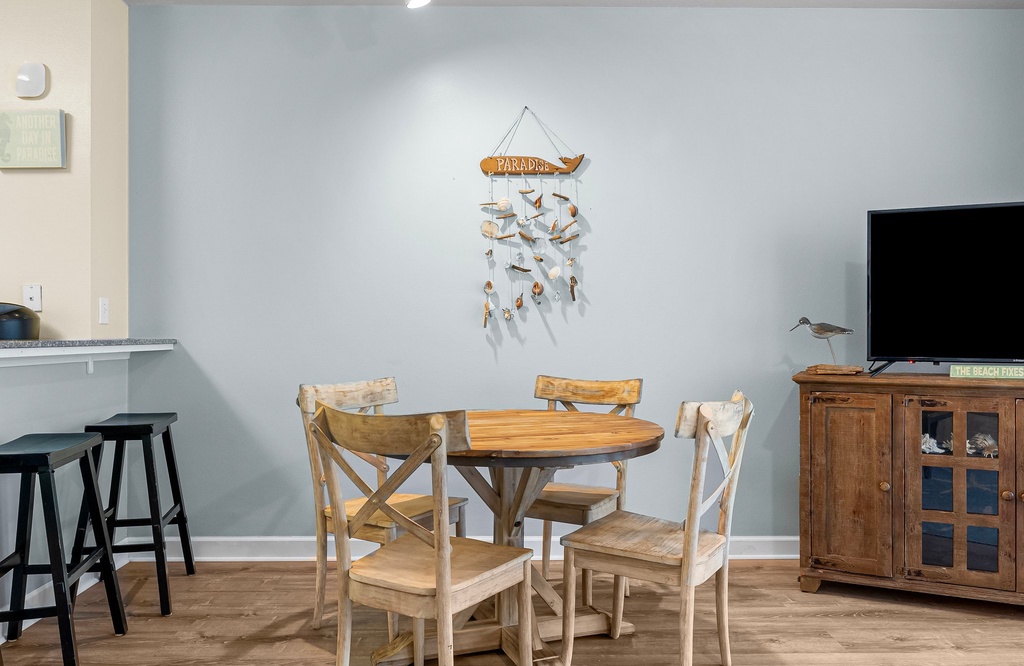 Cozy dining area with rustic wooden table and chairs.