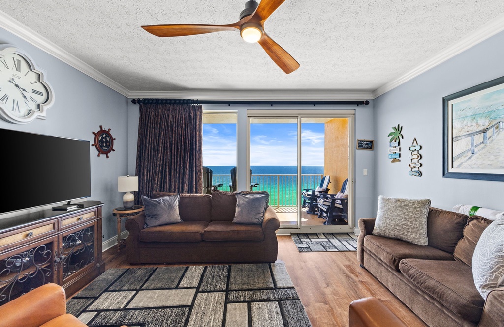 Unwind in your coastal living room where plush seating, charming nautical decor, and a breezy balcony create a soothing seaside escape.