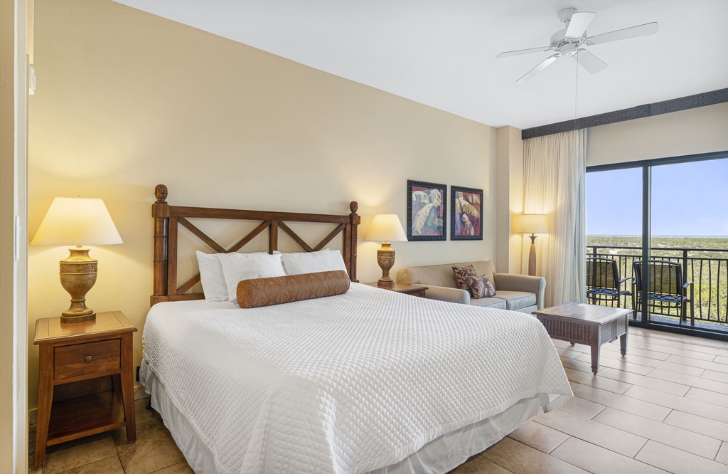 spacious bedroom with king-size bed and balcony access offering natural light