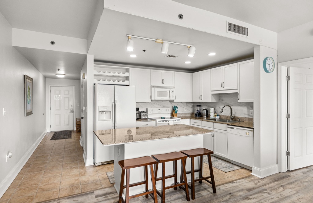 Enjoy preparing meals in your bright, well-equipped kitchen with granite counters, a breakfast bar, and modern appliances—all within an open, airy layout.