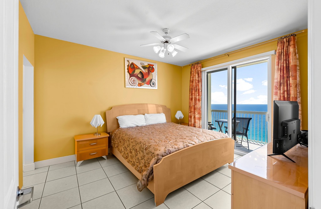 Relax in this bright bedroom with ocean views and balcony access.