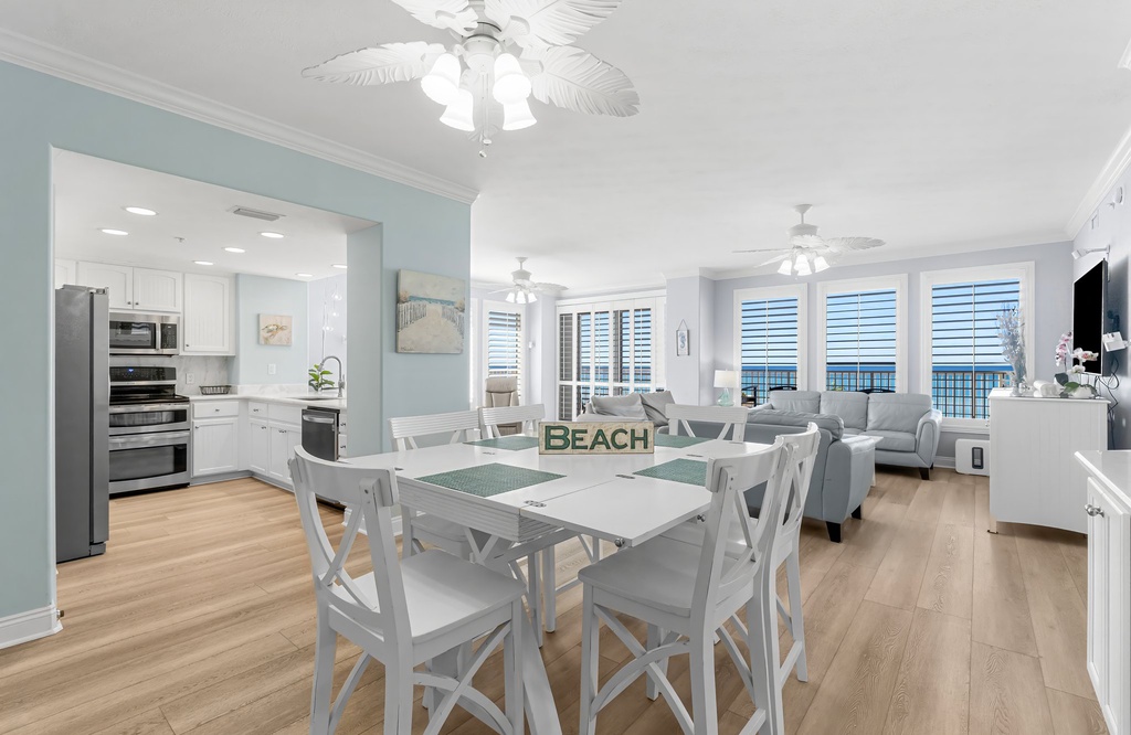 Open-concept dining and living area with ocean views and modern coastal decor