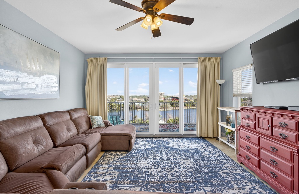 Sink into plush leather seating while enjoying stunning water views through floor-to-ceiling windows in your bright, airy living space.