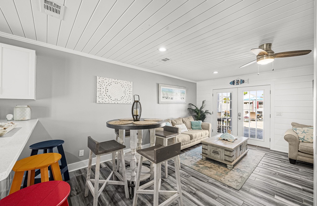 Cozy living area with coastal decor and natural light from french doors