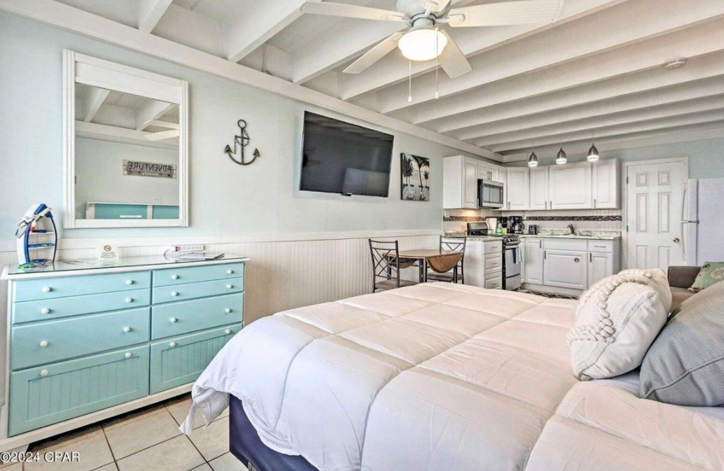 Relax in your bright studio featuring a comfy bed, beachy decor, and full kitchen—everything you need for a perfect coastal getaway awaits.