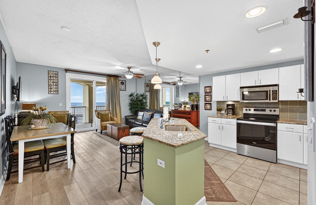 Your open-concept kitchen flows seamlessly into the living area, creating perfect space for cooking and gathering with ocean views.