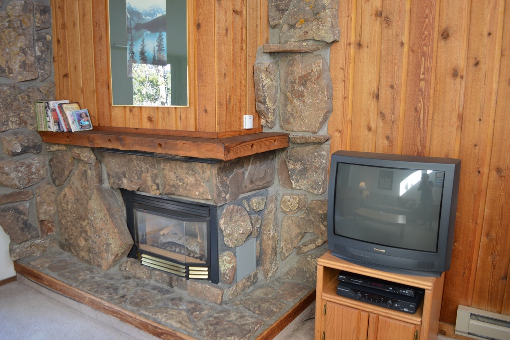 StayWinterPark Beaver Village Condos TV and fireplace in living room unit 834
