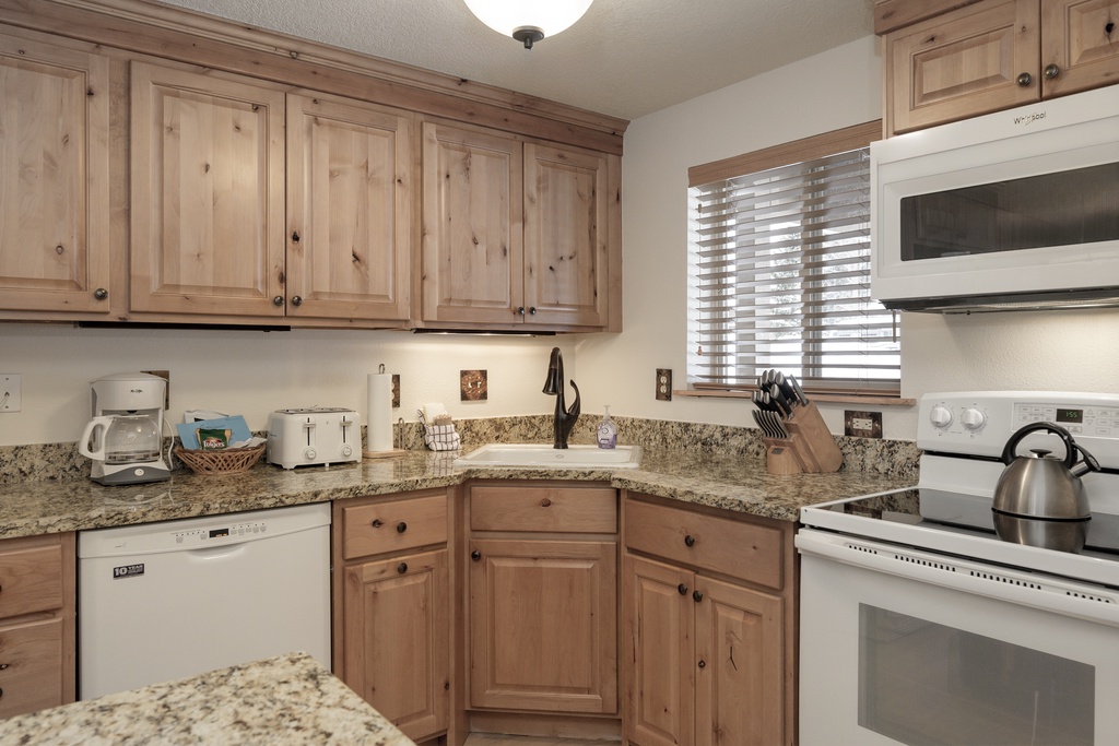 Your fully equipped kitchen features granite countertops, warm wood cabinets, and all the appliances you need to create memorable meals during your stay.