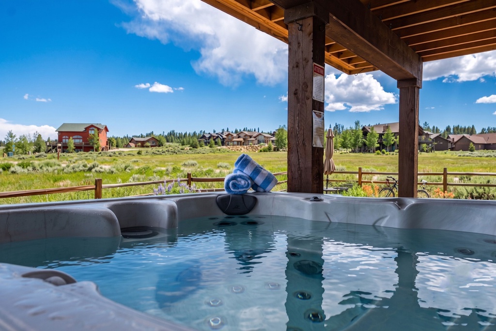 Spacious meadows and forested mountain backdrop border this rural vacation community where the property is located, featuring an on-site hot tub amenity.