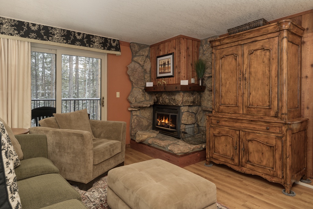 Cozy up in your mountain retreat with a crackling stone fireplace and warm wood furnishings creating the perfect après-ski atmosphere.