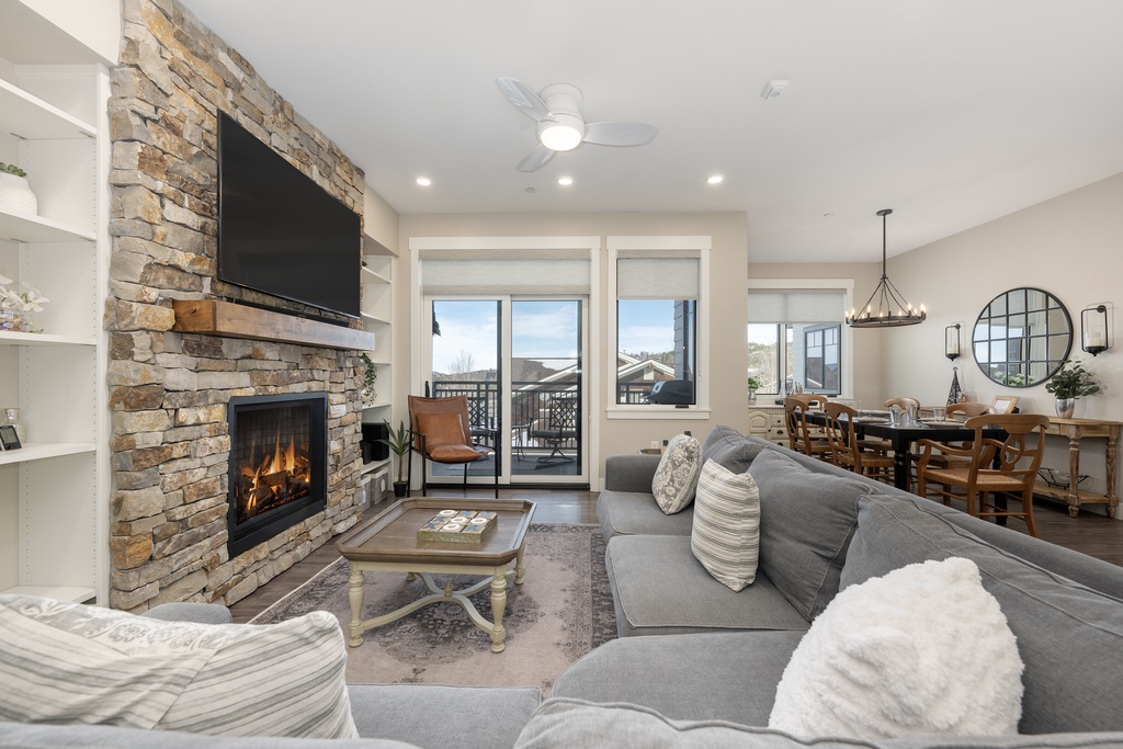 Unwind in your spacious living room where the stone fireplace creates a cozy ambiance and your private balcony offers peaceful views.