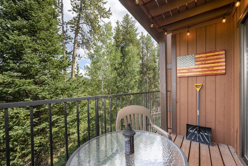 Step onto your private balcony where forest views stretch endlessly before you, complete with outdoor dining and charming string lights for magical evenings.