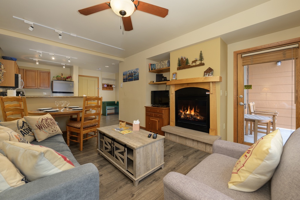 Cozy up by your crackling fireplace with mountain views from this warm living space designed for perfect relaxation.