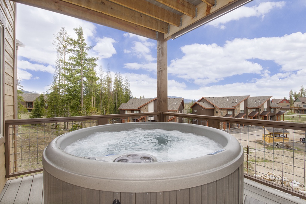 Soak in your private hot tub while taking in stunning mountain views from this covered balcony retreat.