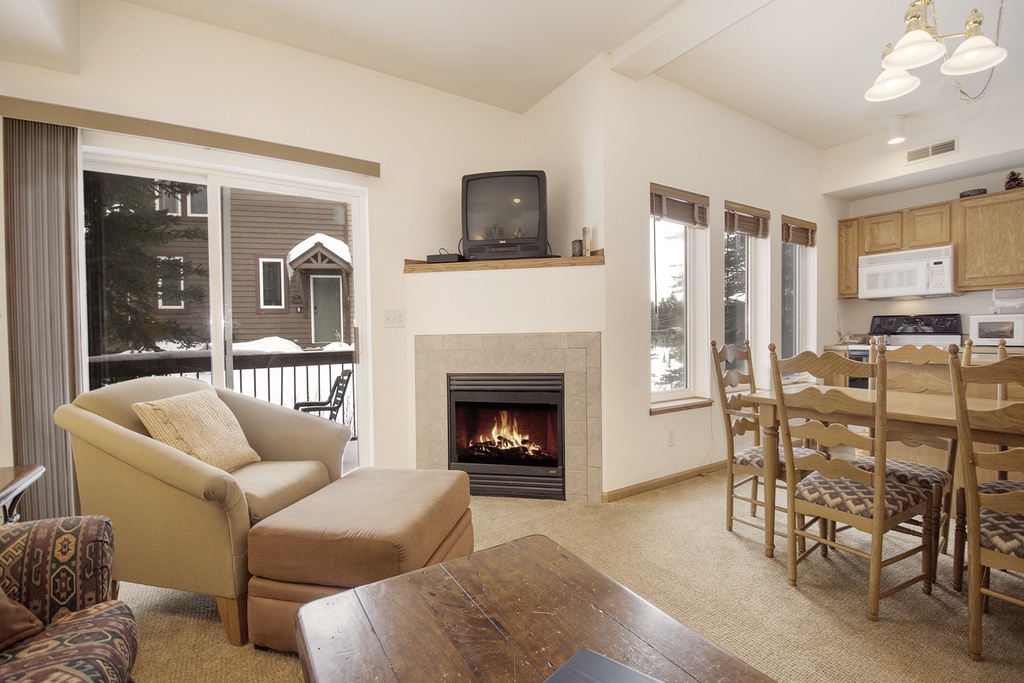 Cozy up by your private fireplace while snowflakes dance outside. This warm living space blends comfort with mountain charm perfectly.