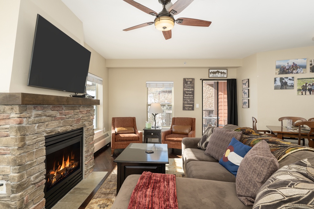 Cozy up by your crackling fireplace while you watch TV in this warm living space with comfortable seating and mountain charm.
