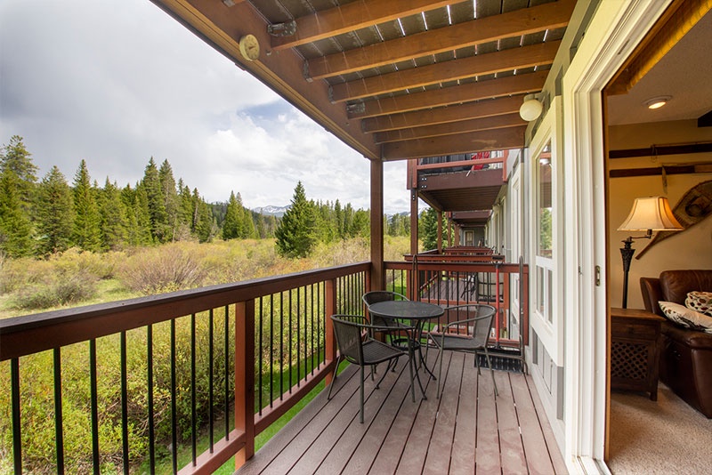 Your private balcony offers stunning forest views where you can enjoy morning coffee surrounded by towering evergreens and peaceful mountain scenery.