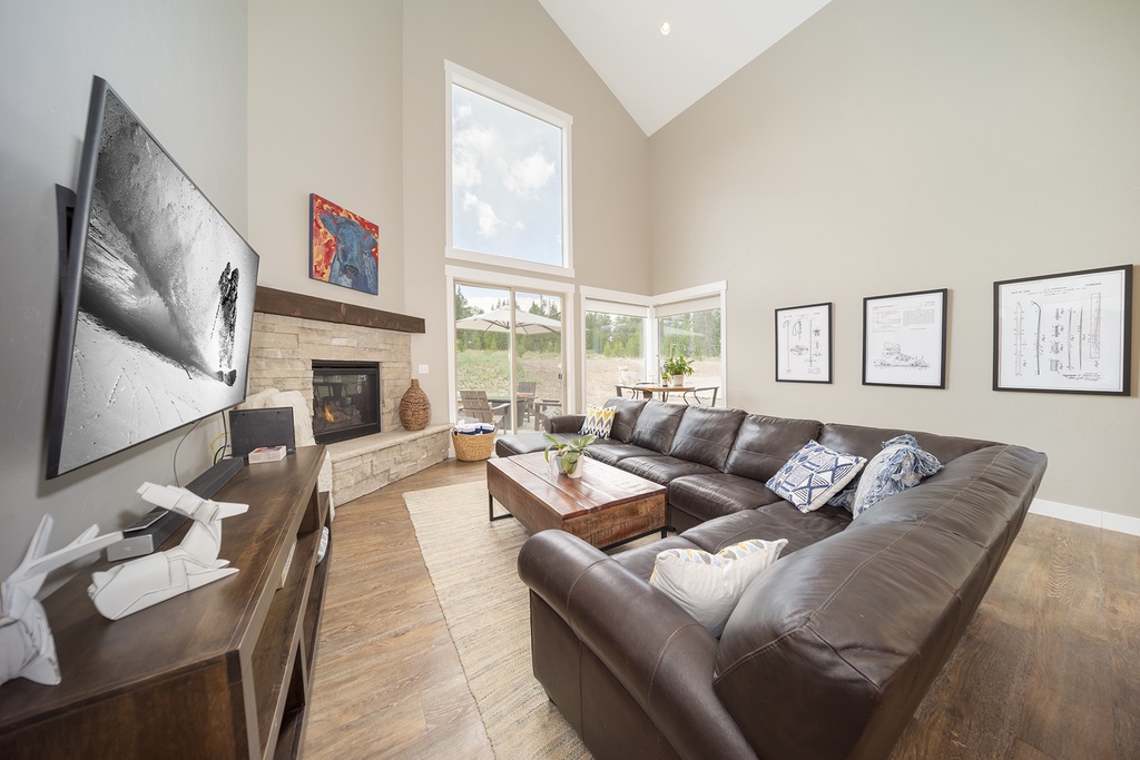 Unwind in your spacious living room with vaulted ceilings, cozy fireplace, and plush leather sectional perfect for movie nights.