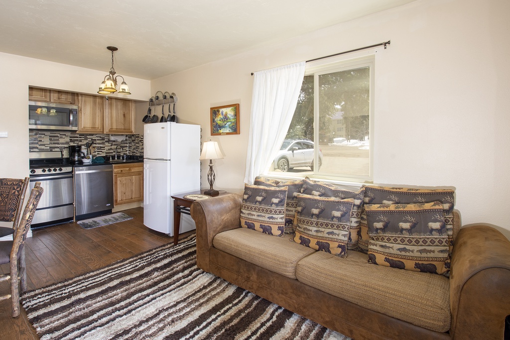 Sink into your comfortable sofa and enjoy this cozy open-concept living space where rustic charm meets modern convenience in your home-away-from-home.