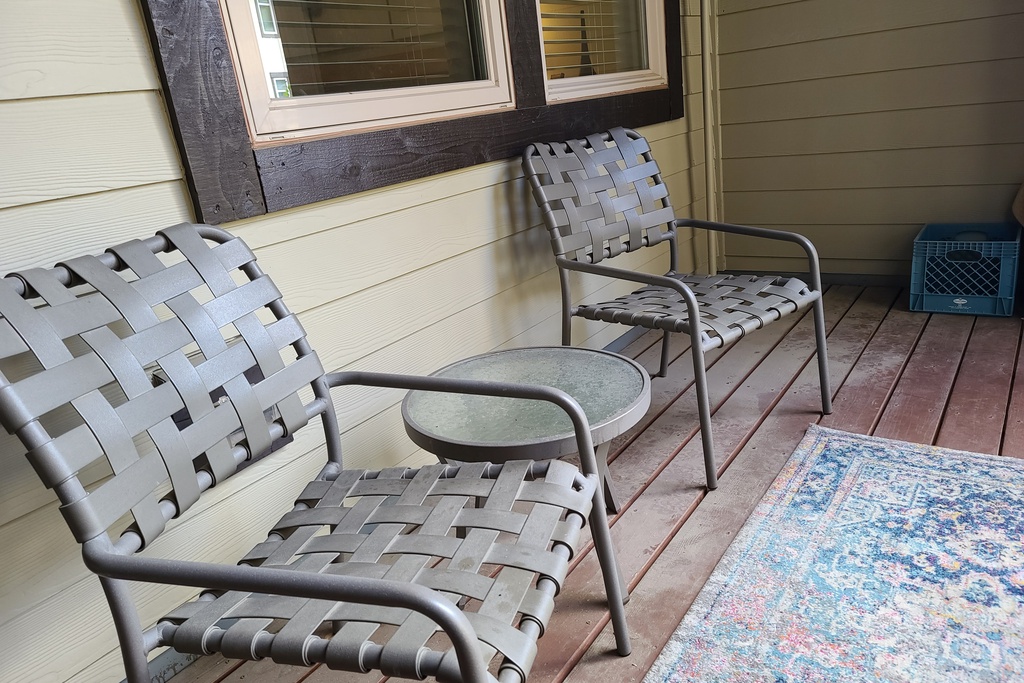 Step onto your private covered patio and settle into stylish woven chairs where you can unwind with morning coffee or evening conversations.