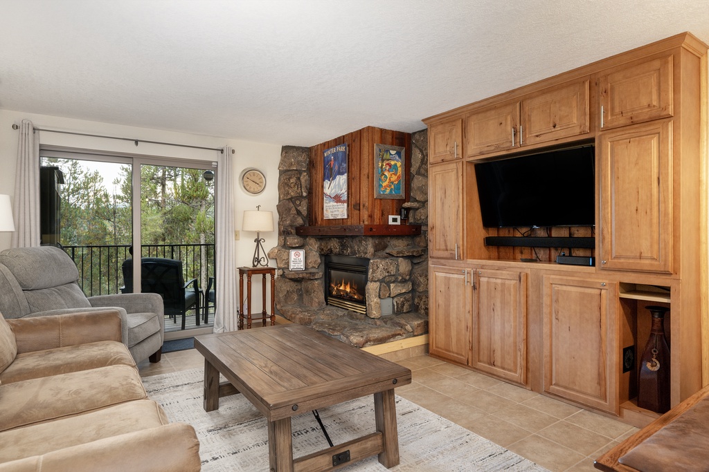 Cozy up by your crackling stone fireplace while enjoying mountain views from your private balcony in this warmly appointed living space.