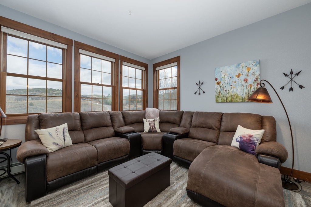 Sink into plush leather seating while gazing at scenic countryside views through your large windows—perfect for cozy movie nights.