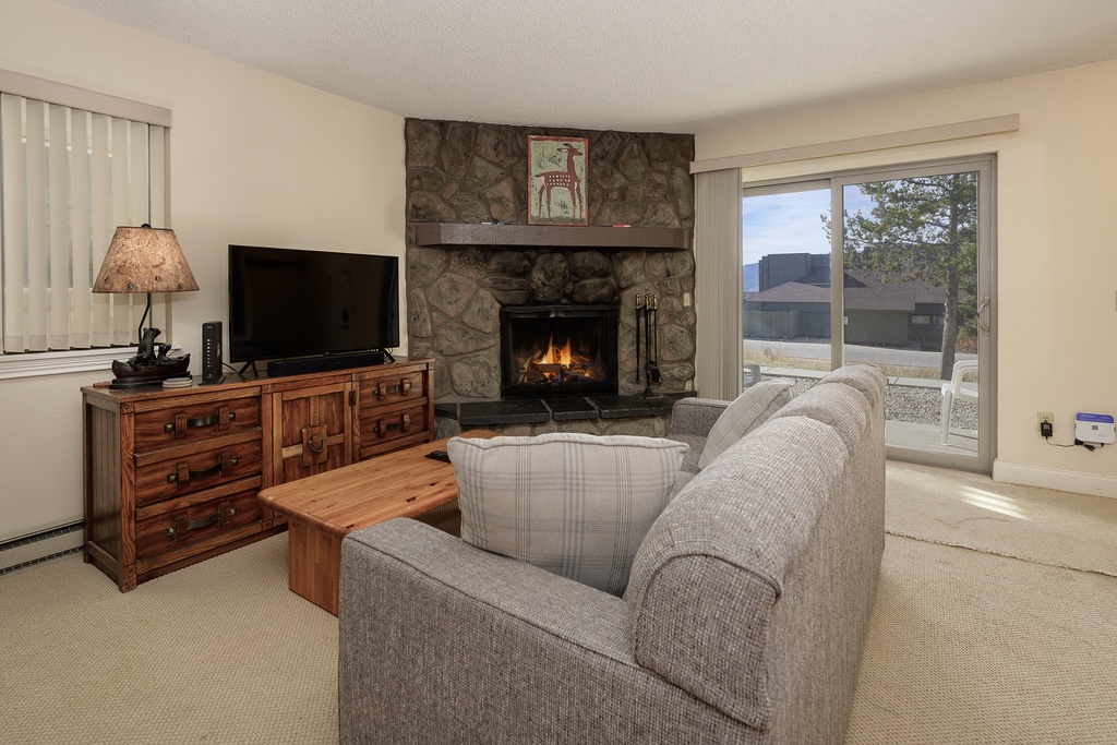 Cozy up in your living room with a crackling stone fireplace and comfortable seating for perfect mountain evenings.