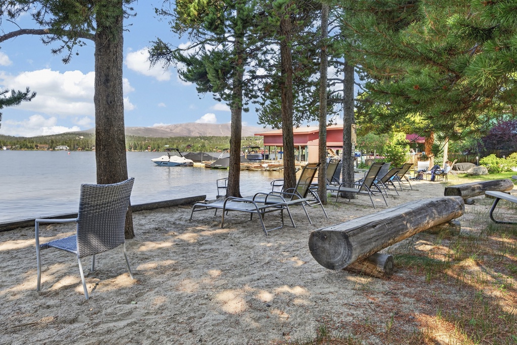 Relax on your private sandy beach with a stunning lakefront setting surrounded by towering pines and mountain views—perfect for peaceful mornings or sunset lounging by the water.
