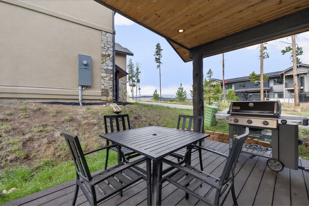 Your covered patio invites open-air dining with a four-seat table and gas grill, perfect for savoring meals while taking in the peaceful natural surroundings.