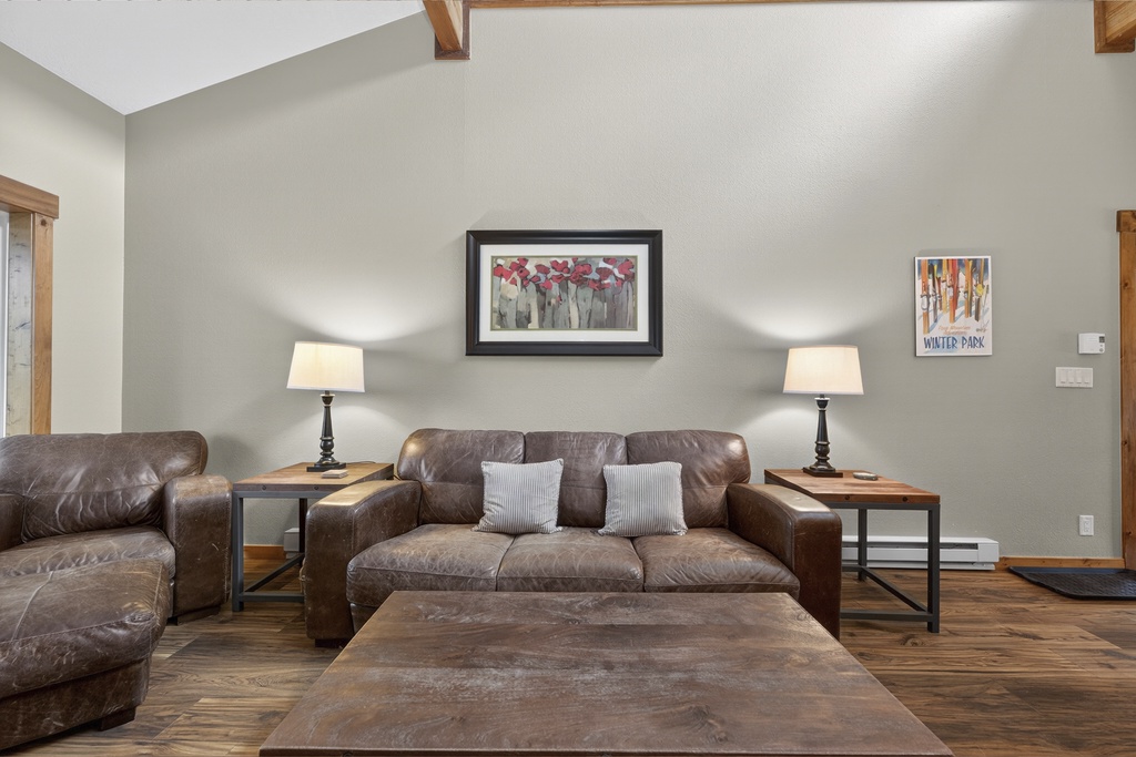 Sink into plush leather sofas with soft pillows, surrounded by warm wood accents and glowing lamps—your perfect spot to unwind after a day of adventure.
