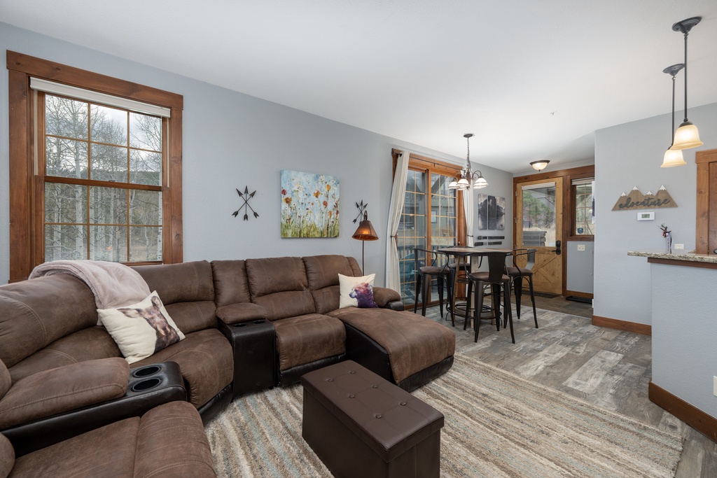 Unwind on this plush sectional where natural light streams through large windows, creating your perfect spot to relax after mountain adventures.