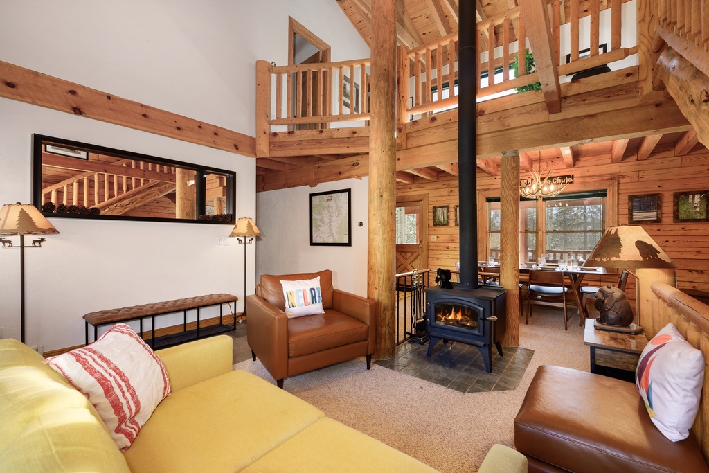 Cozy up in your rustic living room with exposed beams, crackling fireplace, and leather seating perfect for mountain evenings.