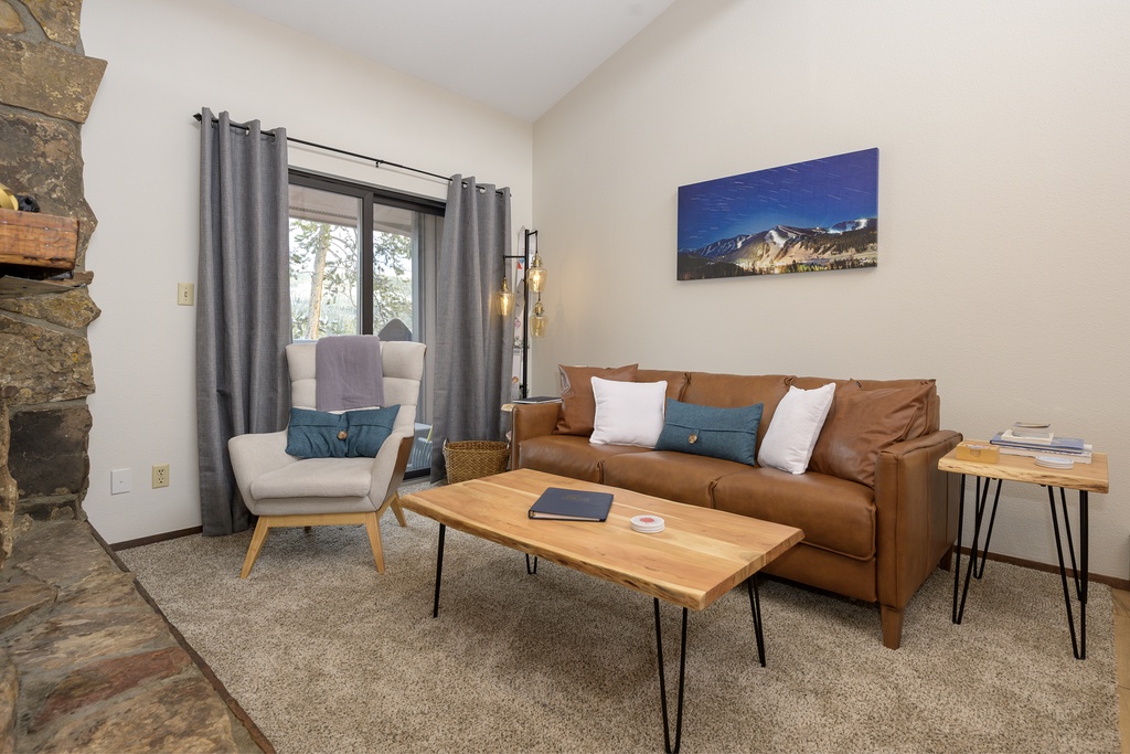 Sink into the plush leather sofa and unwind in your stylish mountain retreat, where rustic charm meets modern comfort.