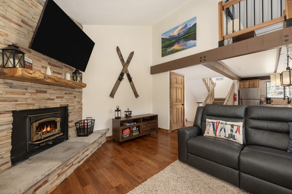 Curl up by your crackling fireplace in this rustic-chic living space, where exposed beams and mountain charm create the perfect alpine retreat.